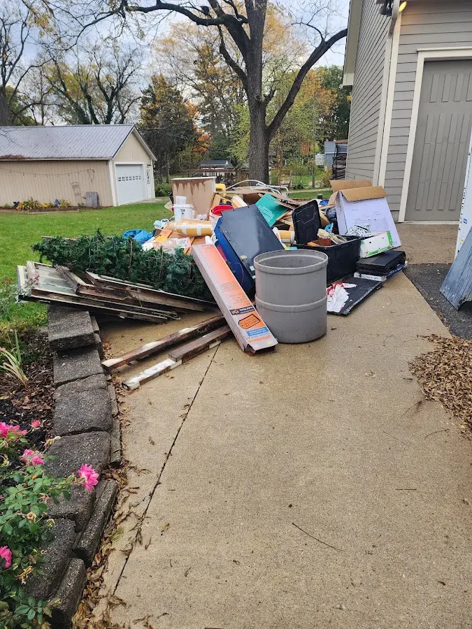Dumpster being loaded with debris for 12 Yard Dumpster Rental in Coraopolis